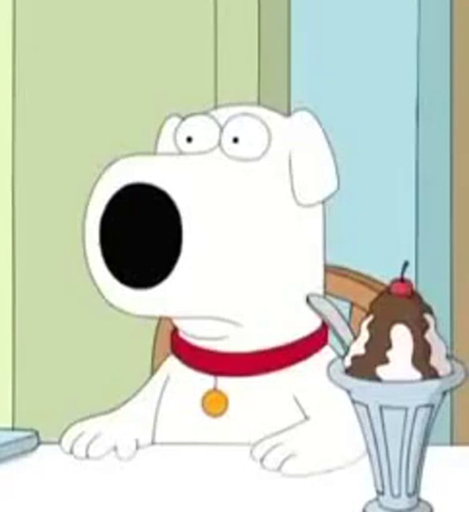 a cartoon dog is sitting at a table with an ice cream sundae in front of him .