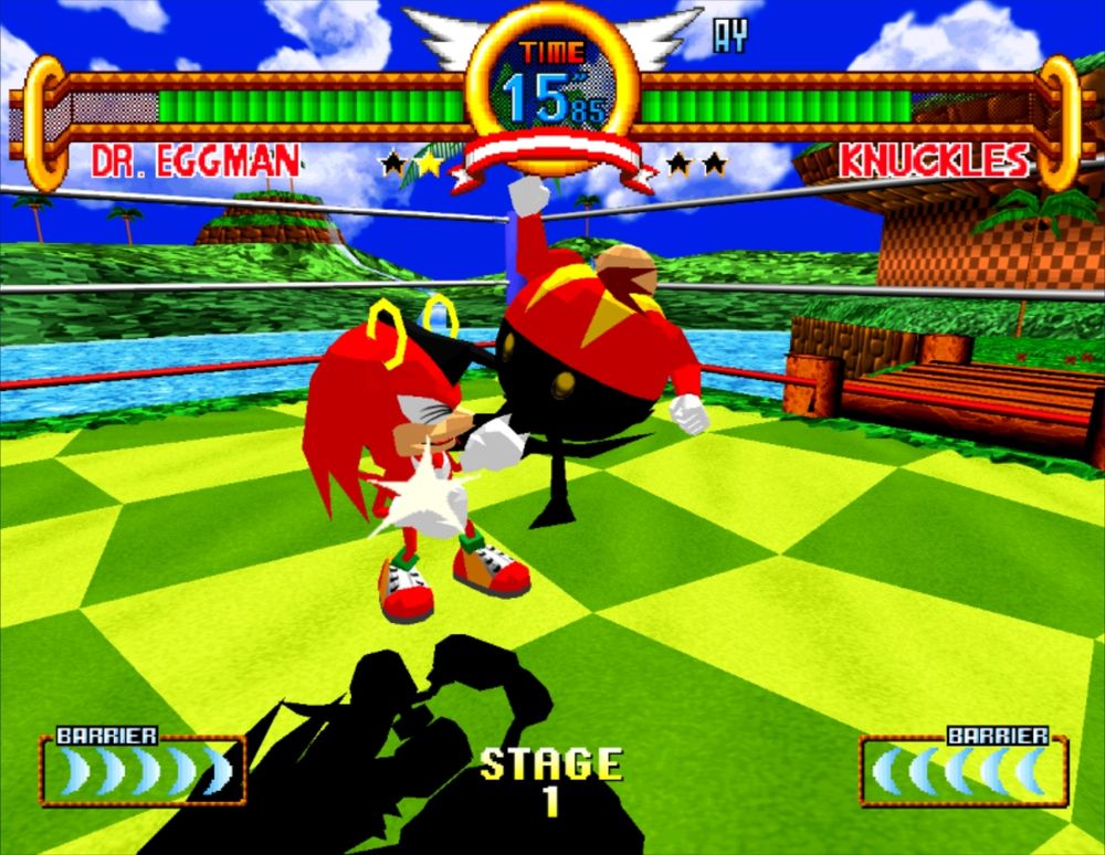 A screenshot of Sonic the Fighters Community Edition, a mod for the PS3 port of Sonic the Fighters, via RCPS3. In the South Island stage, Dr. Eggman, without his mech, is gleefully kicking Knuckles in the face.