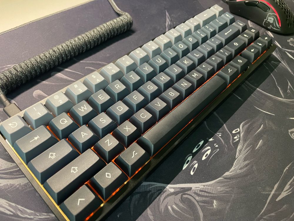 Mechanical keyboard on deskmat with octopus pattern. 