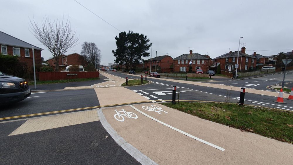 Continuous surface across Lethbridge Road junction with priority markings for cyclists.