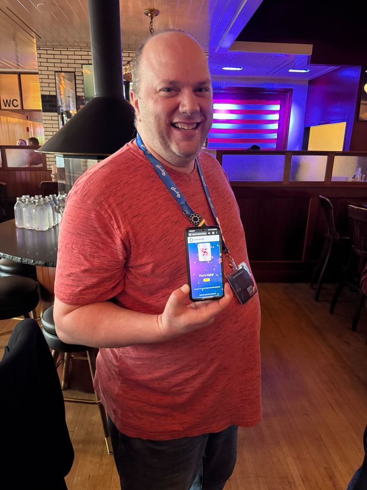 Cory Knox holding phone opened to janestreet's answer page for their puzzle deck.