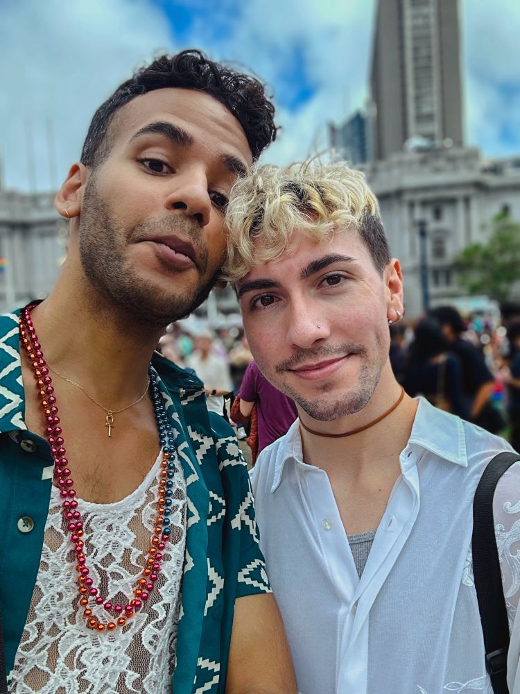 Mikah Sargent and his partner, Sebastian, smile at the camera.