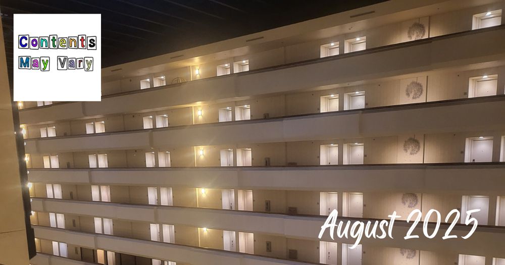 a photo of a wall of hotel rooms lit up in the dark