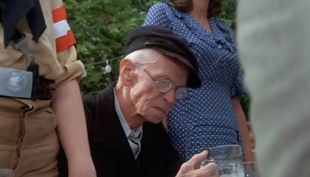 From CABARET (1972), an old man stares into his beer glass, in a state of both incomprehension and sad realization, as the crowd around him rises to sing "Tomorrow Belongs To Me".