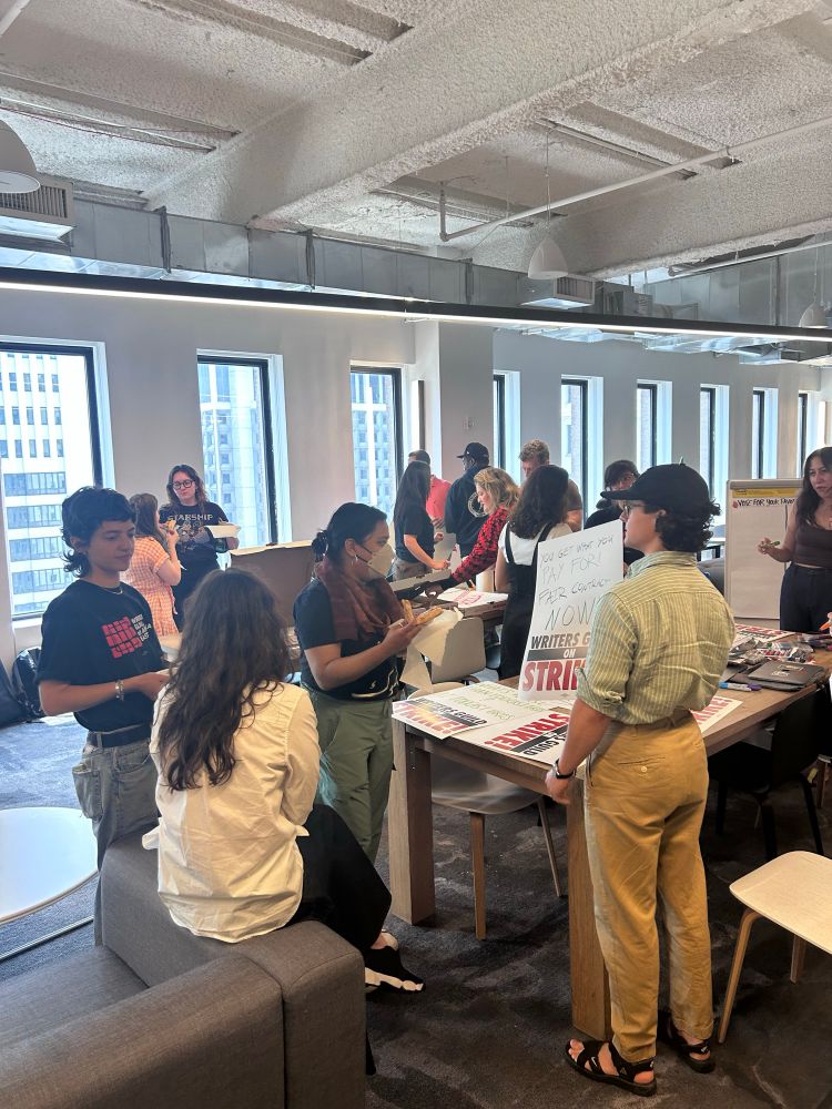 Vox Media workers creating handmade signs.