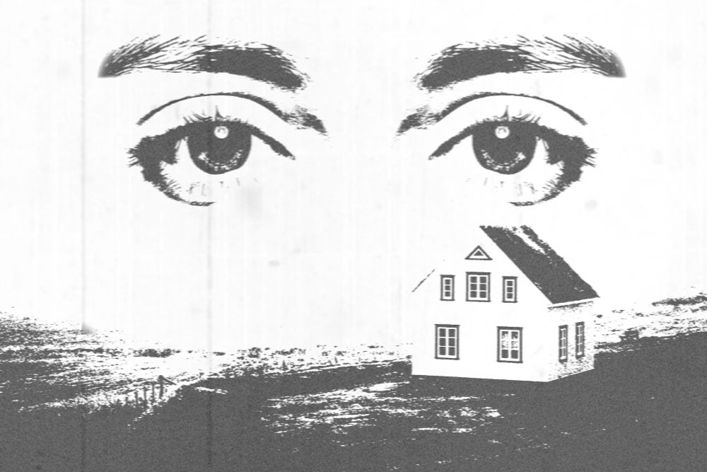 Black and white image of an isolated house on a field with a pair of eyes staring at the viewer.