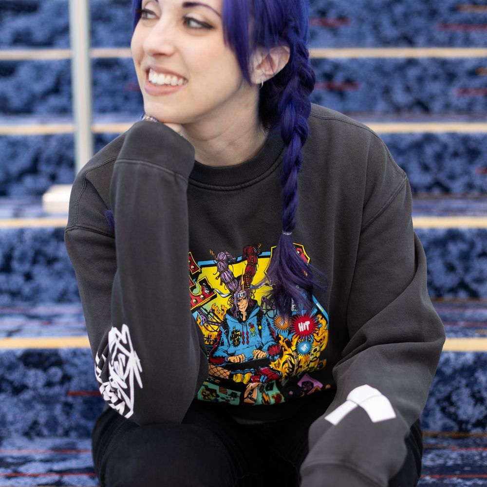 Woman in braids sitting on a staircase in an Evo brand shirt