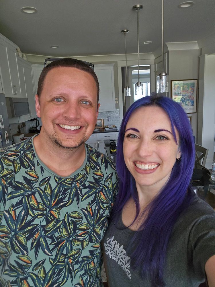 Two adults taking a selfie in a kitchen