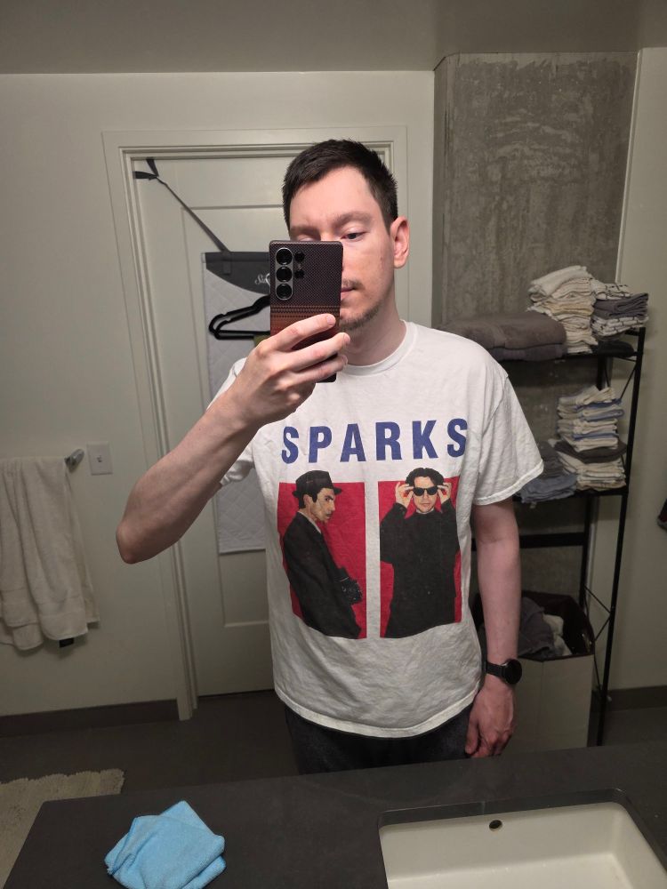 A bathroom mirror selfie of me wearing a Sparks t-shirt