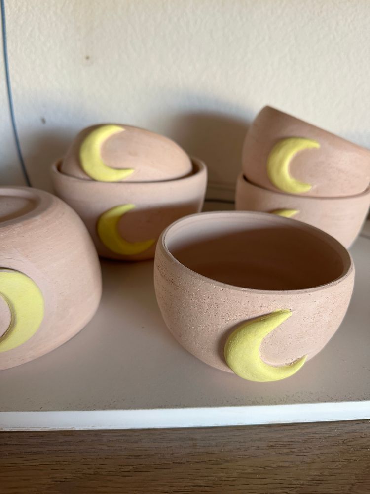 Close of up of bisque moon mugs and bowls. Work in progress