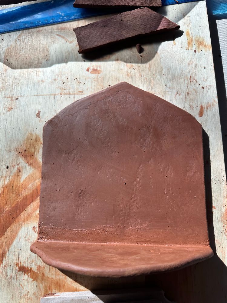 Single pane altar made from red clay