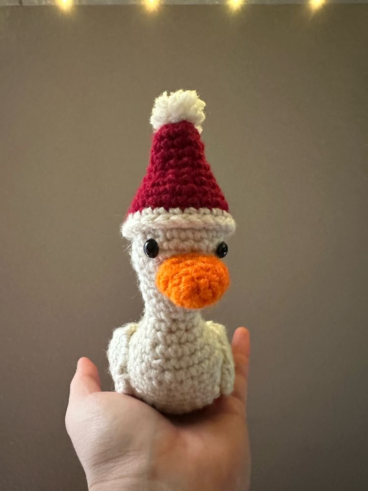 Cute crochet goose with tiny adorable Santa hat for the winter festive season holiday