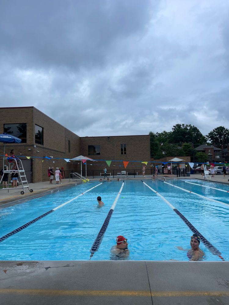 The end of warm ups at a Grown Up Swimming meet. There’s only a few people left in the water. The sky is threatening to rain once again. 
