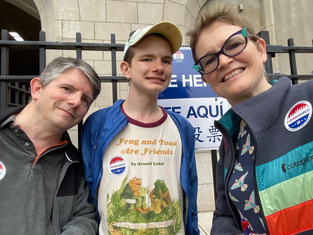Three people pose outside a polling place after casting their ballots in the NYC mayoral primary.