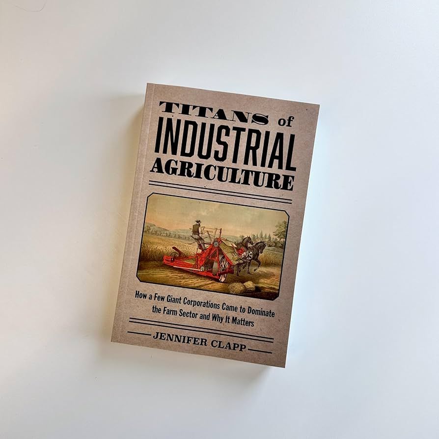 Front cover of Titans of Industrial Agriculture depicting a horse drawn  19th century harvesting machine. 