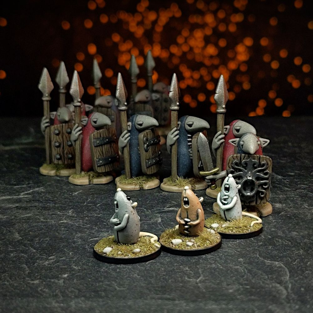 Miniatures of three singing cloth rats lead a snaking conga line of cloth goblin miniatures.