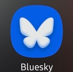 Round blue square with a white butterfly symbol in the middle. 
