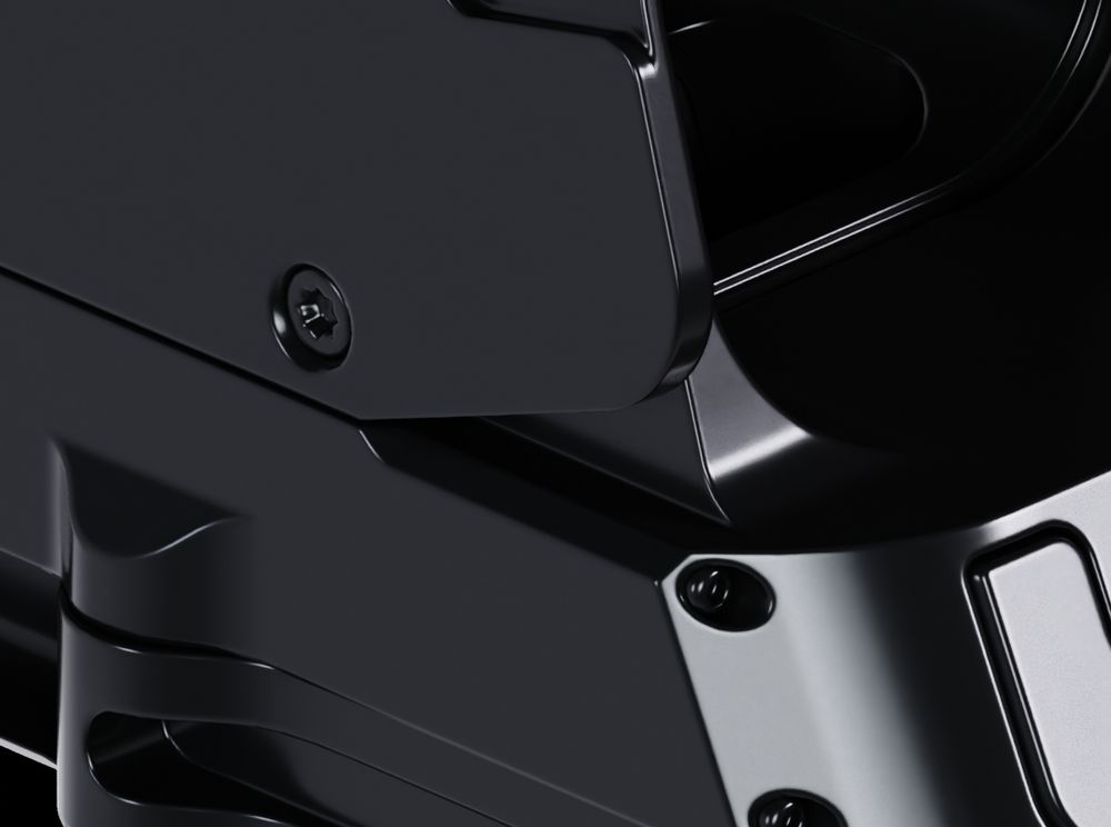 A hard-surface model with beveled edges, with a dark, smooth, metallic material. Some screws, curves, and cutouts are visible.