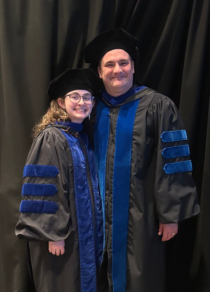 A picture of myself (left) and my postdoc mentor (right) in PhD regalia. 