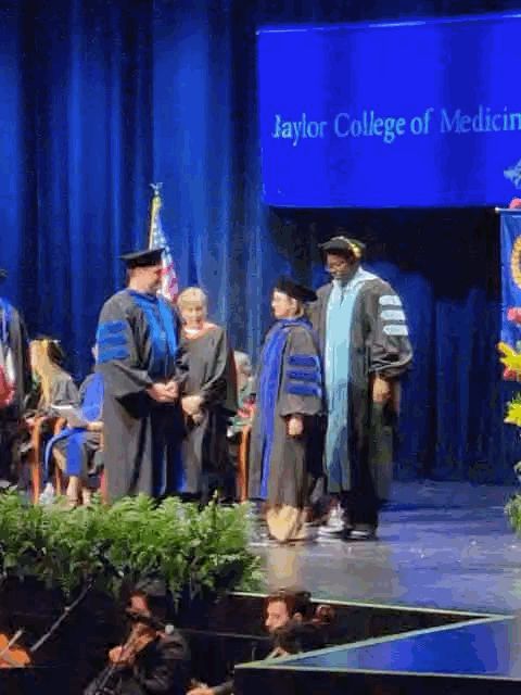A gif of my postdoc mentor and I hugging after I was hooded for my PhD on the graduation stage. 