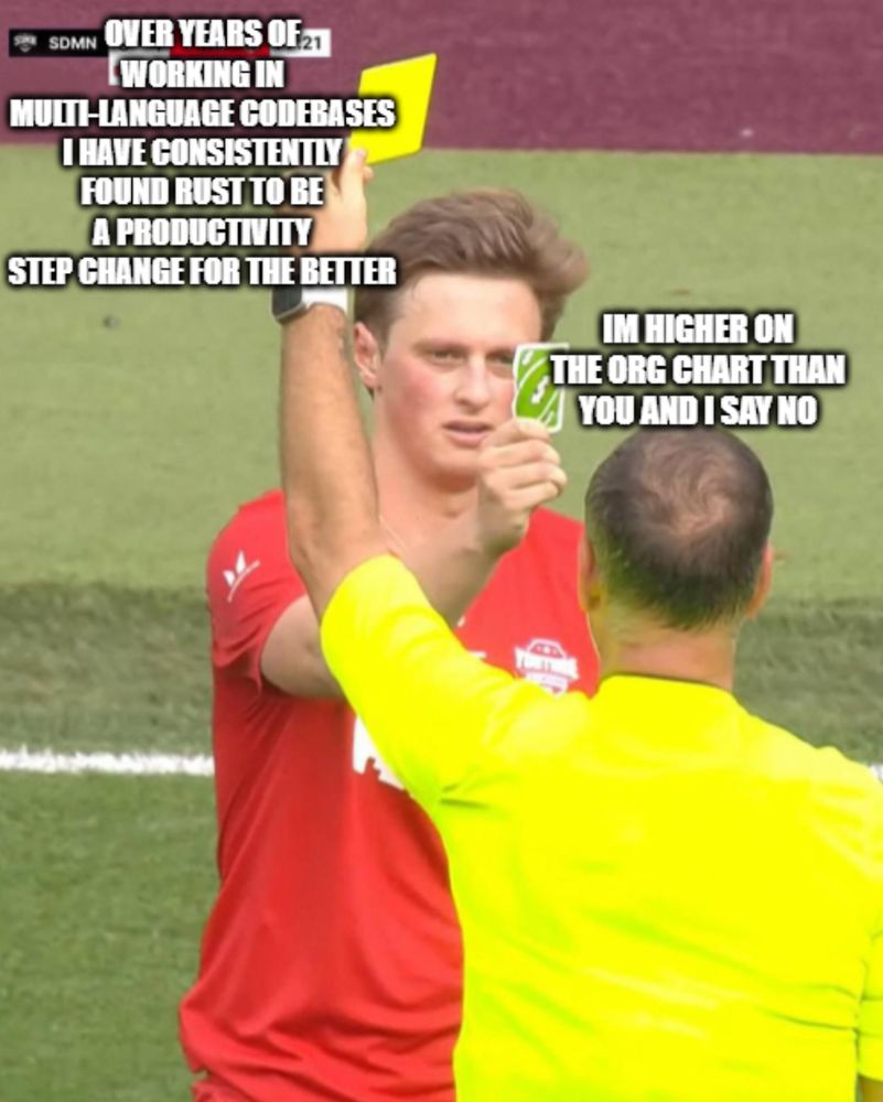 referee holds up a yellow card stating "over years of working in multi-language codebases I have consistently found rust to be a productivity step change for the better" but the footballer has an uno reversal card that says "im higher on the org chart than you and I say no"