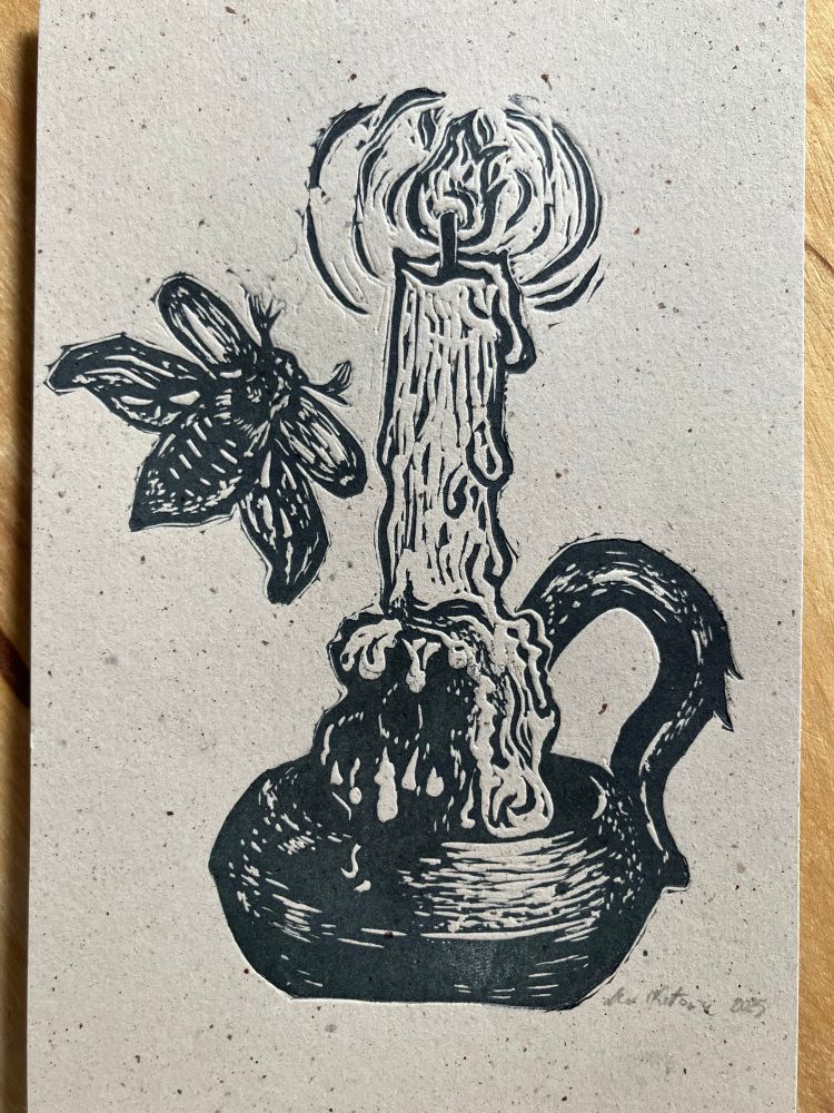 a relief print on recycled paper showing a melted lit candle in 19 century candle holder. there’s a black beetle flying towards the flame.
