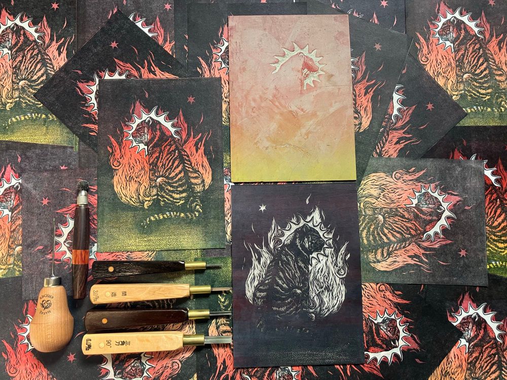 prints arranged with two linocut blocks and carving tools