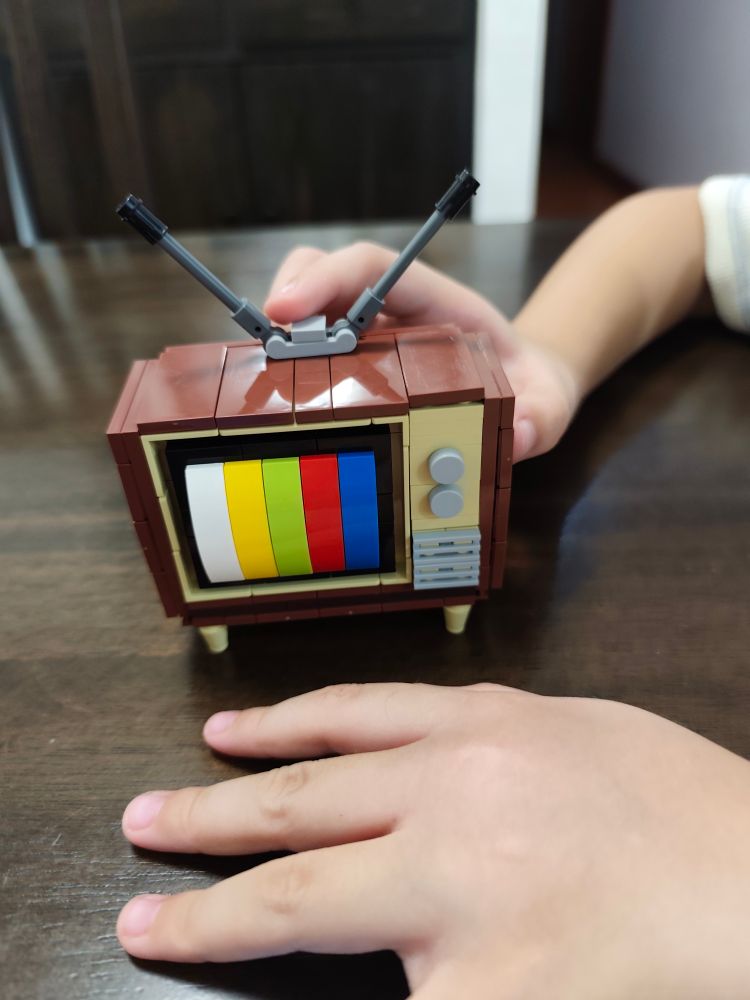 A block kit model of a CRT TV with rabbit ears antennae.