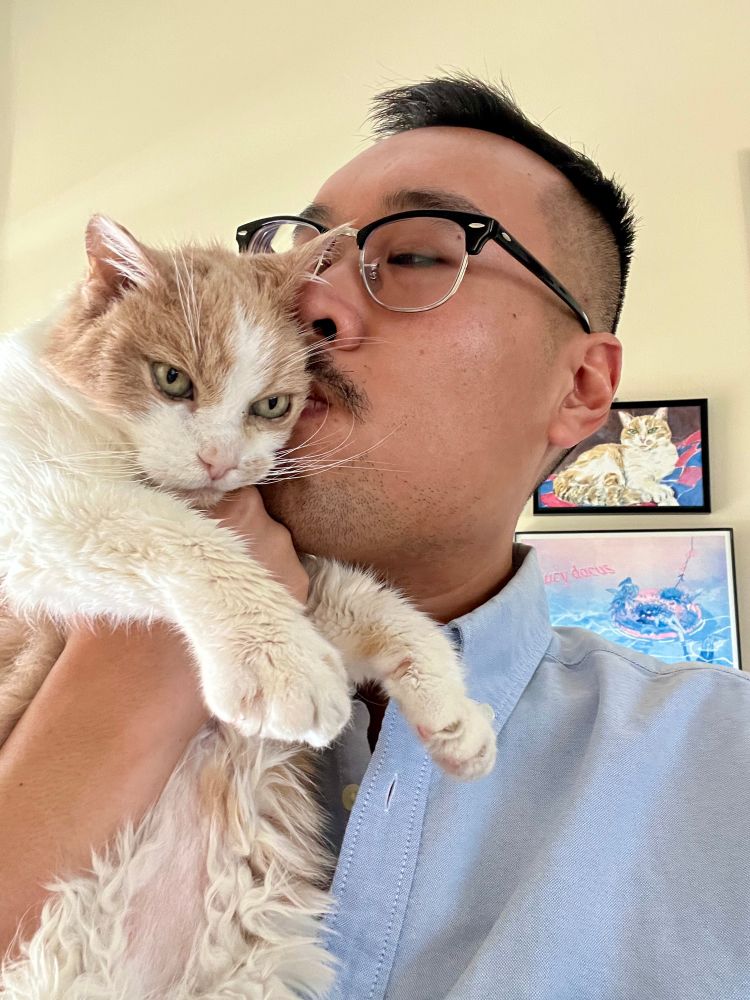 Catsby being kissed on his head by a man who will miss him very very much 