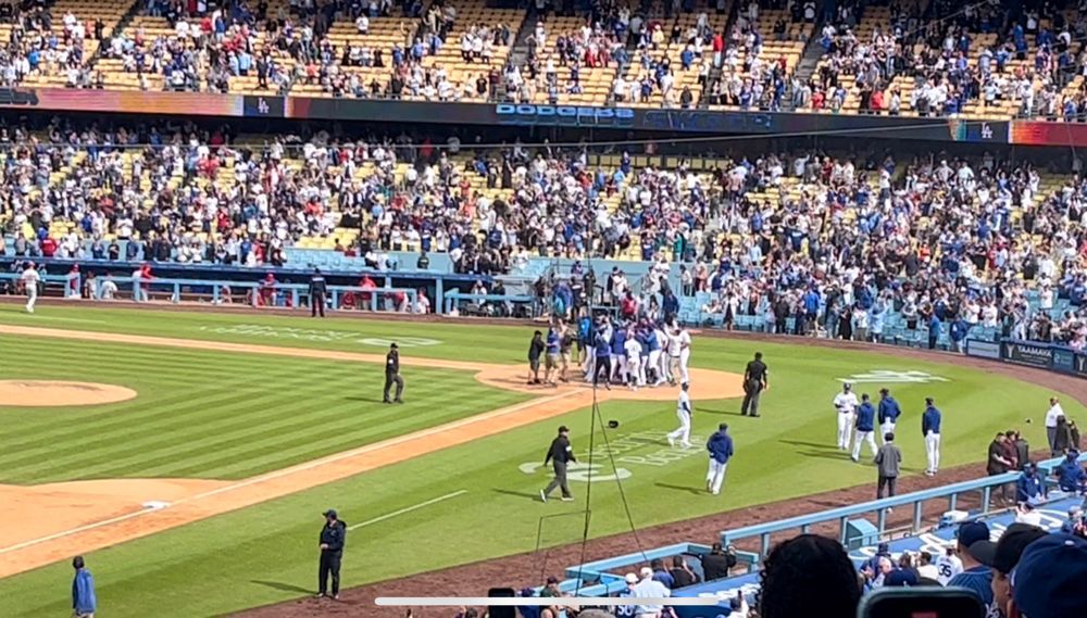 The Dodgers celebrate at home plate following Max Muncy’s grand slam home run that won the game 10-6 against the Philadelphia Phillies. 