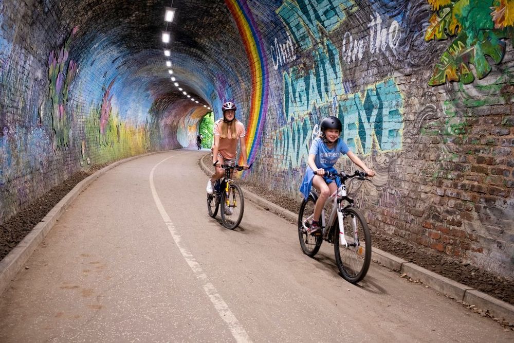 Two teenagers riding bikes in Colinton Tunnel, Edinburgh.