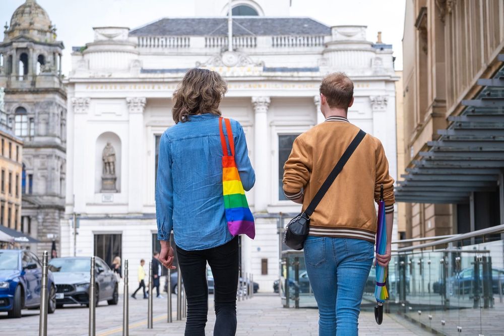Queer adults walking in a city centre public space