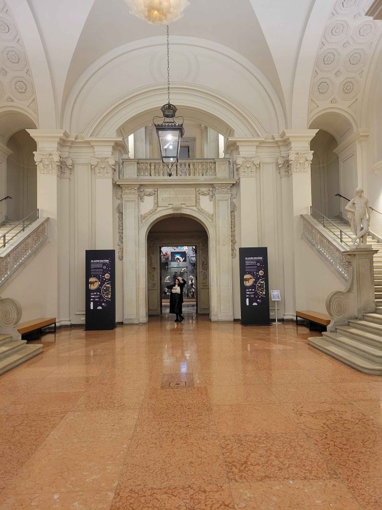 Juliette at a neoclassical museum striking a pose 