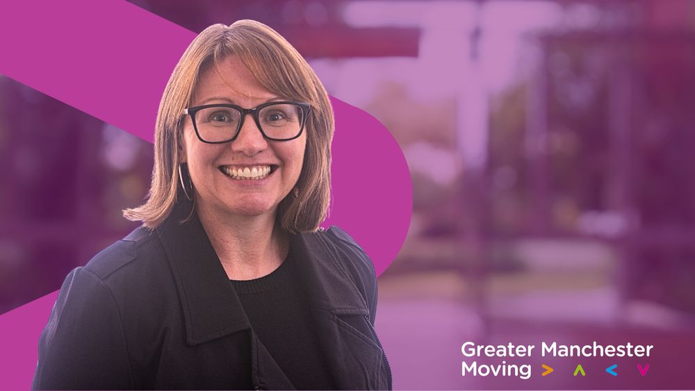 Claire Tomkinson stands in front of a purple GM Moving branded background.