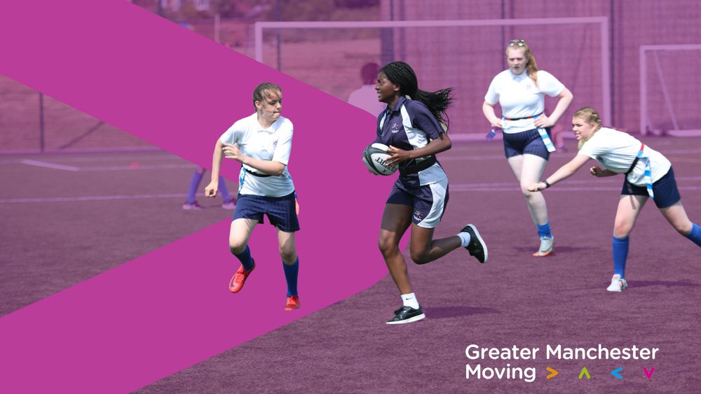 A group of girls play rugby on a sports pitch. The background is a branded purple GM Moving graphic, featuring the > symbol.