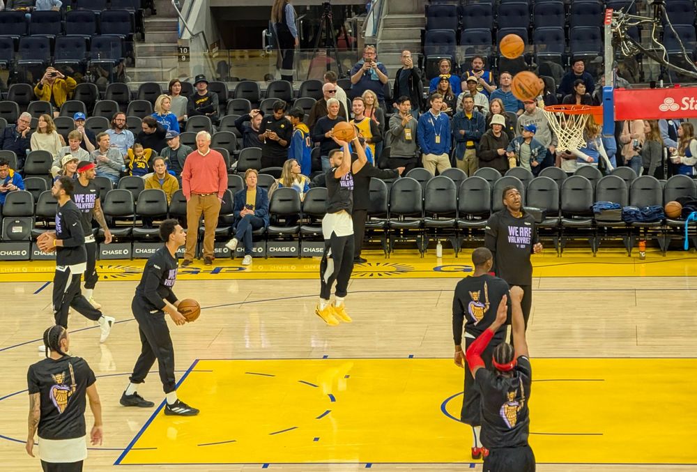 Golden State Warriors warming up prior to a game, Steph Curry shooting a jump shot. 