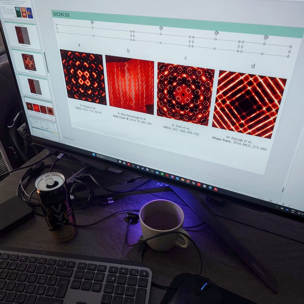A computer screen with an opened power point presetnation. On the slide, still incomplete, four single crystal total scattering patterns are on display with mezmerising intensities in geometrical shapes. The patterns and diffuse scattering is shown in "hot" colour scheme.