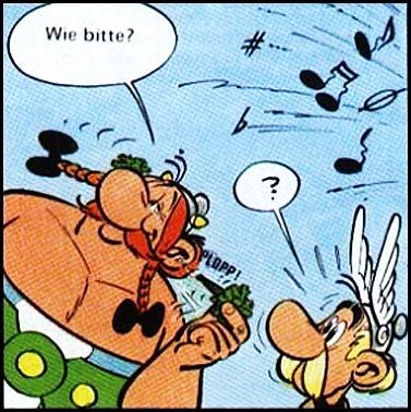 Asterix und Obelix: Im Bild wird die schreckliche Musik von Troubadix visualisiert und Obelix zieht sich ein Bund Petersilie aus dem Ohr und fragt Asterix "Wie bitte?". Asterix reagiert verdutzt.