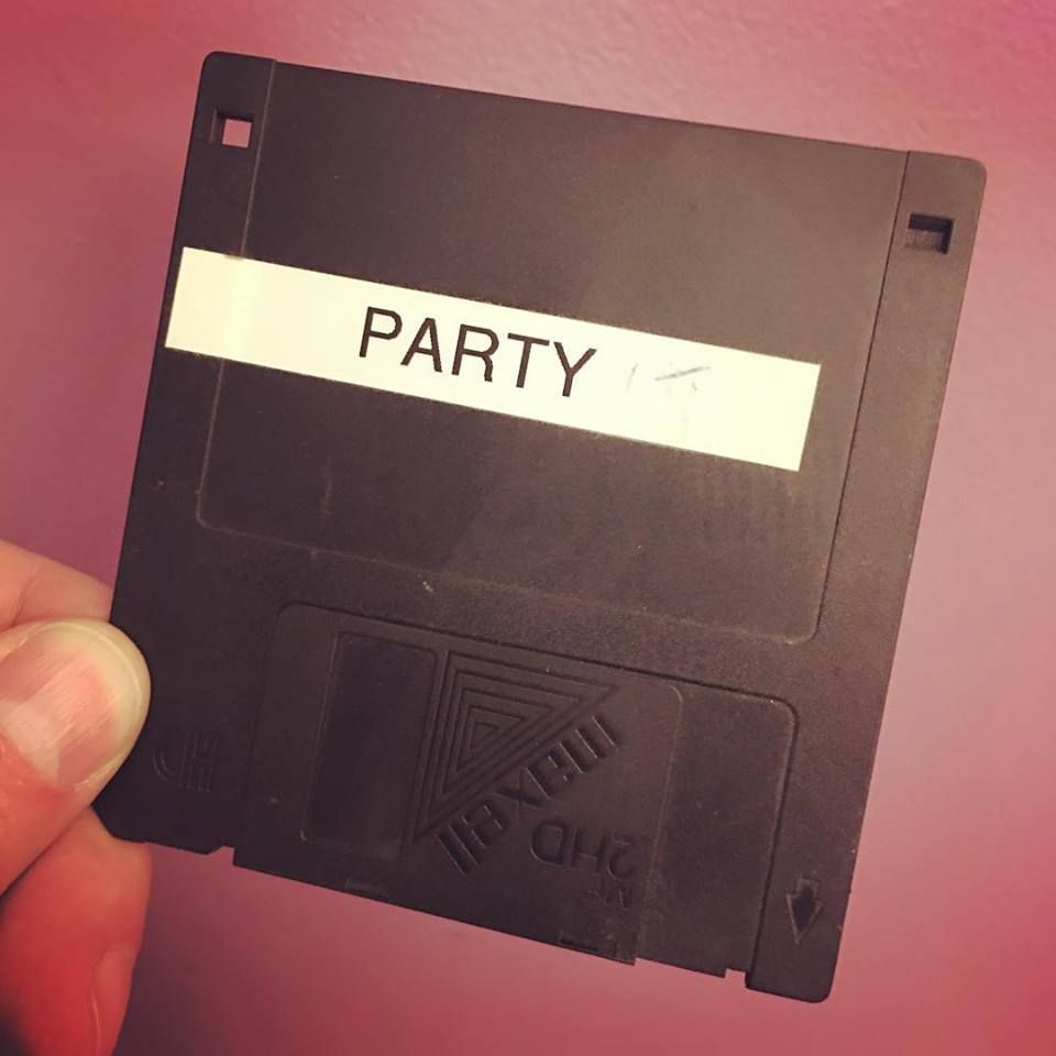 A dusty black floppy disc labeled "party"