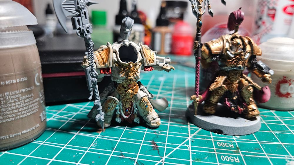 A headless allarus terminator shield captain.

One of the Emperors gene crafted personal guards, and soldiers.
Her name is Elizabeth, and she has been alive since the Heresy.
She is on a desert planet fighting an ork waaaagh which is a lot of orks in one place.