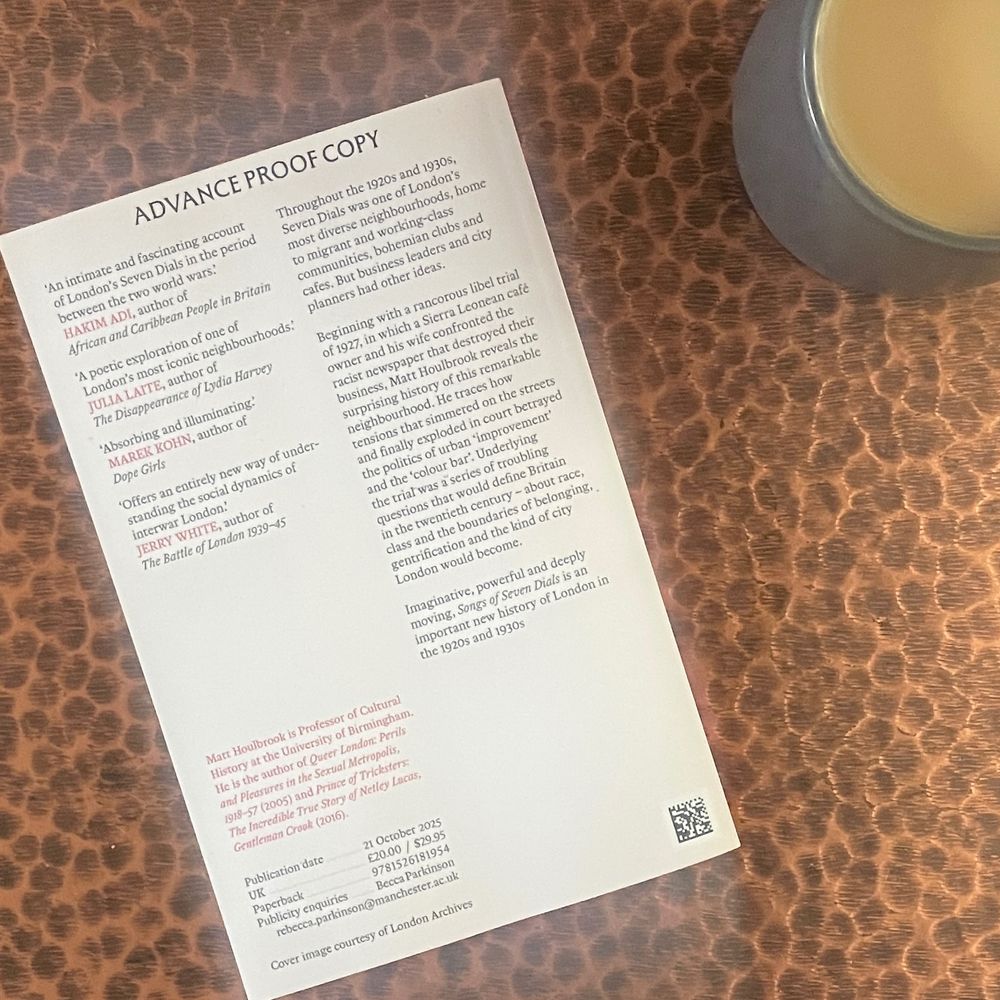 An advance proof copy of Matt Houlbrook's book Songs of Seven Dials: An intimate history of 1920s and 1930s London, which will be published in October 2025. The cover shows a map of Seven Dials in 1938 and is pink.