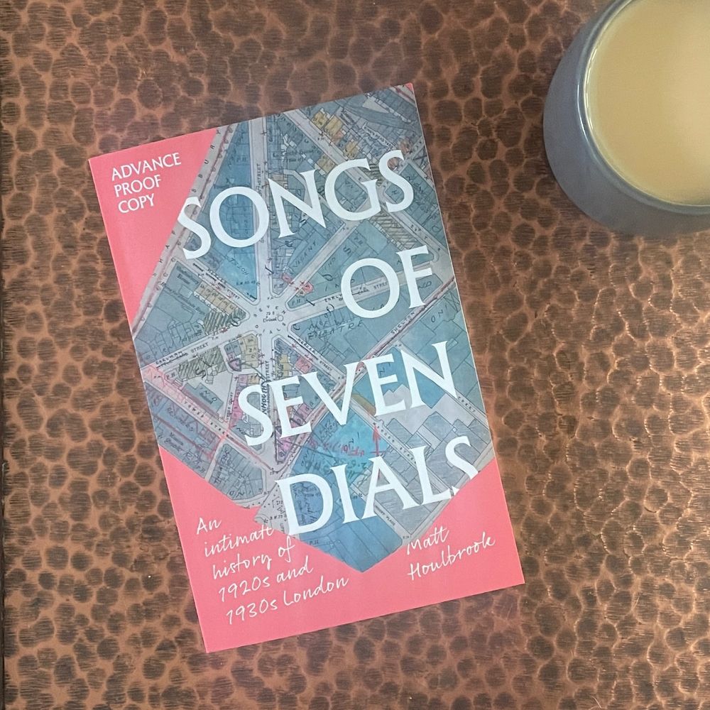 An advance proof copy of Matt Houlbrook's book Songs of Seven Dials: An intimate history of 1920s and 1930s London, which will be published in October 2025. The cover shows a map of Seven Dials in 1938 and is pink.