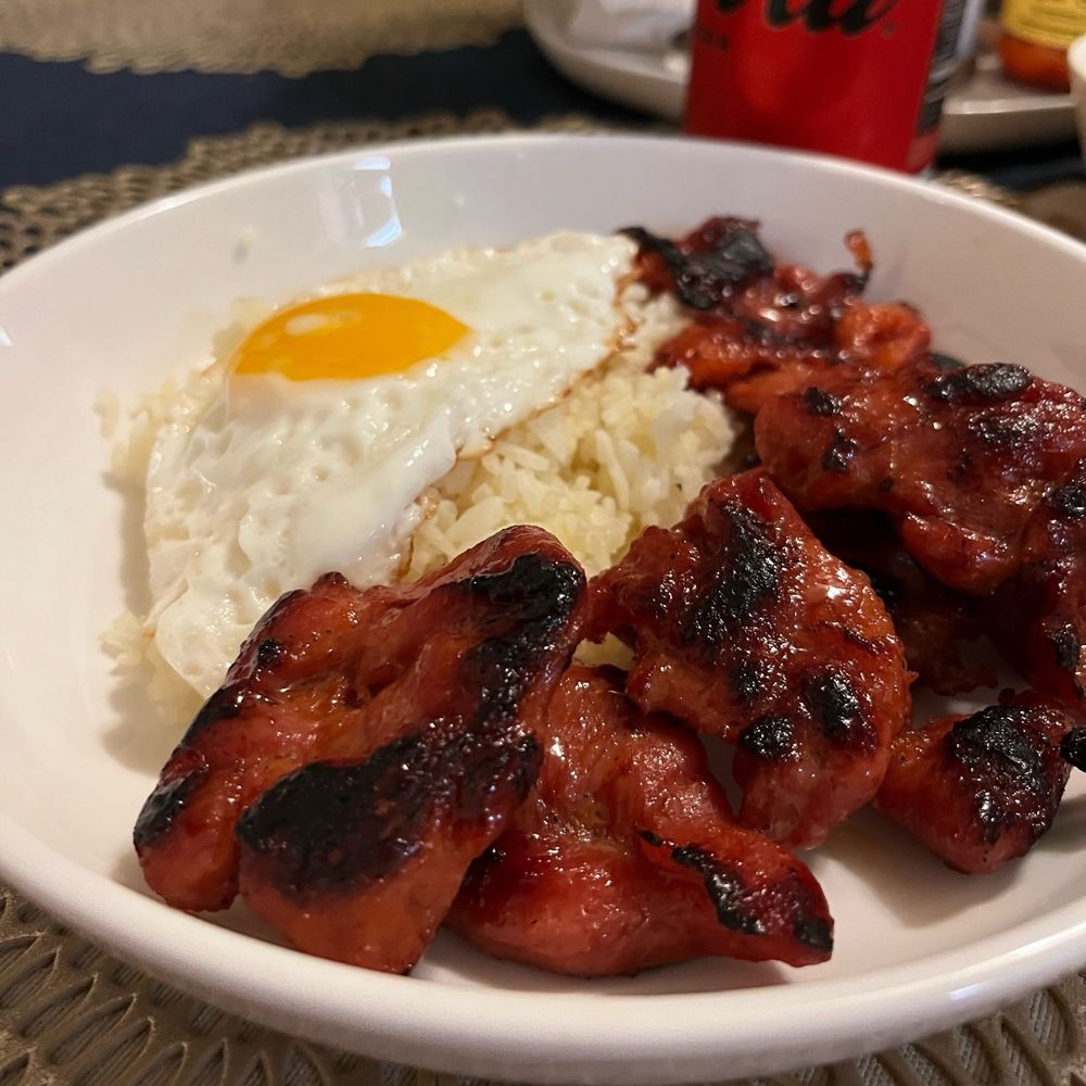 Plate of red tosilog, rice, and a sunny-side up egg