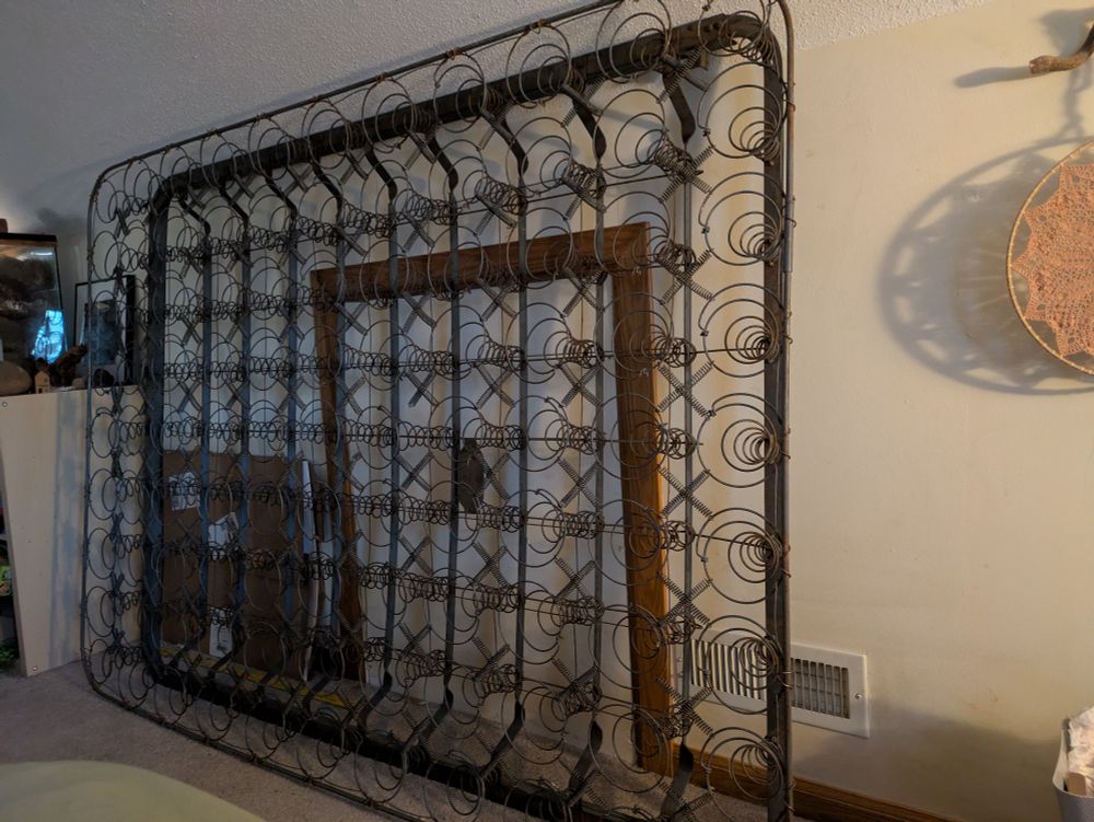 One of those old, open spring units for a vintage/antique bed where there is no fabric covering anything, it is just a series of coils all tethered together with smaller springs on a metal frame. It looks industrial and strange propped up against the wall of my bedroom
