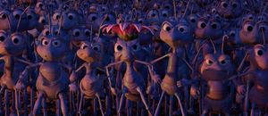 Dense crowd of animated angry ants lock arms in defiance to oppose a tyrant. scene from Disney movie, A Bug’s Life.