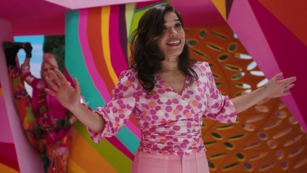 America Ferrara (a woman with wavy brown hair and pink clothes) ranting about the hypocrisies of being a woman in the Barbie movie