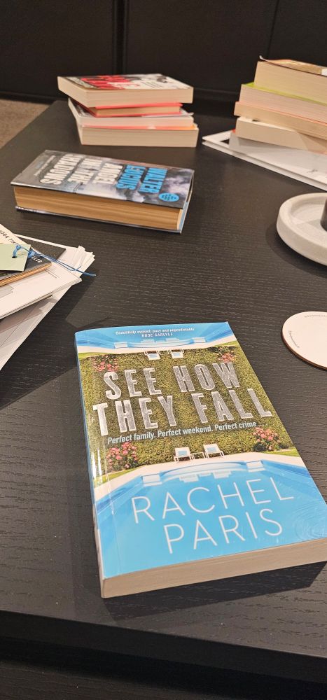 Coffee table with books in piles, featuring NZ author Rachel Paris' new novel, see How They Fall.
