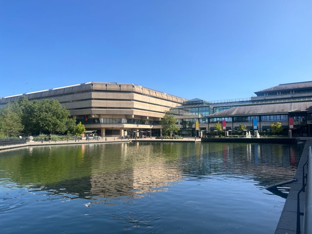 National Archives building in Kew. A large concrete and glass building with an expanse of water at the front. 
