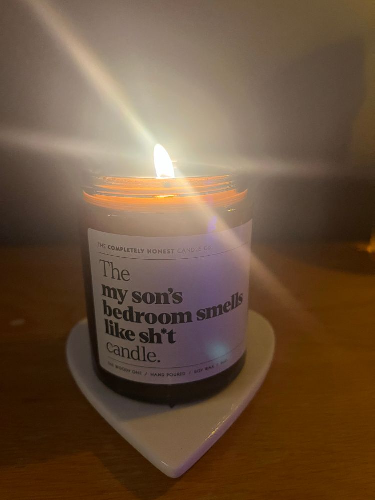 A burning candle with the caption my son’s bedroom smells like shit candle.