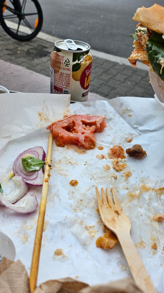 a half eaten and discarded thick slice of tomato
